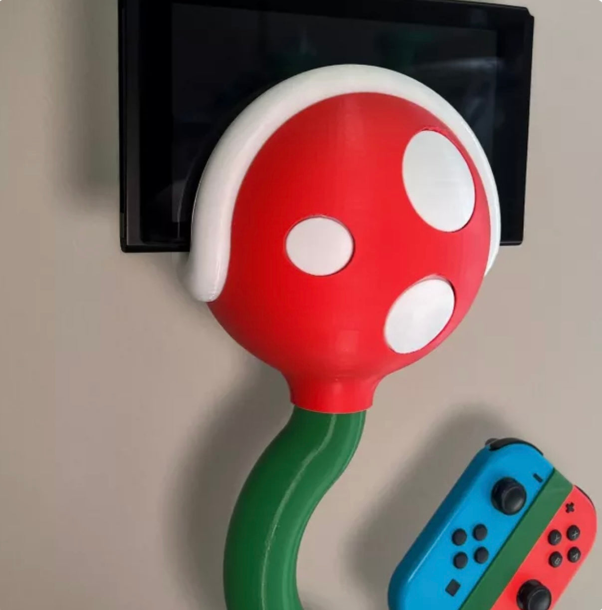 Cannibal flower game console stand holding Nintendo Switch with game card slots and USB base