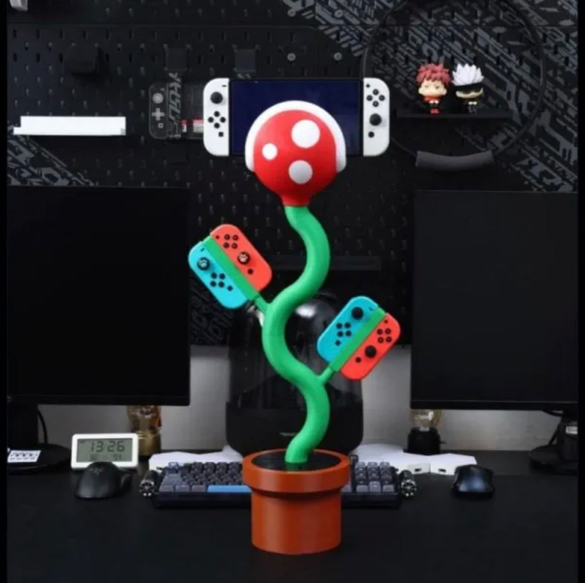Cannibal flower game console stand holding Nintendo Switch with game card slots and USB base
