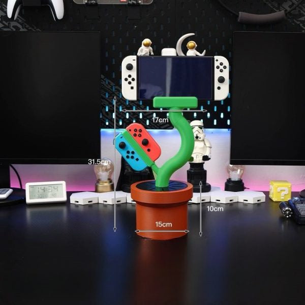 Cannibal flower game console stand holding Nintendo Switch with game card slots and USB base