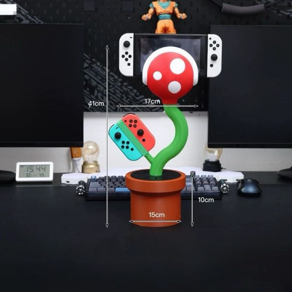 Cannibal flower game console stand holding Nintendo Switch with game card slots and USB base