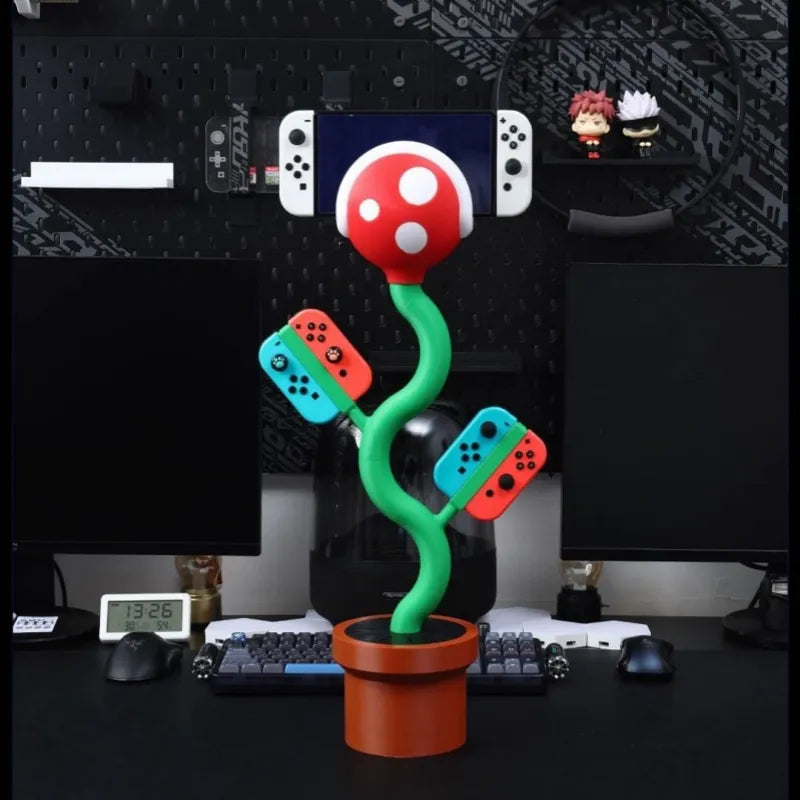 Cannibal flower game console stand holding Nintendo Switch with game card slots and USB base