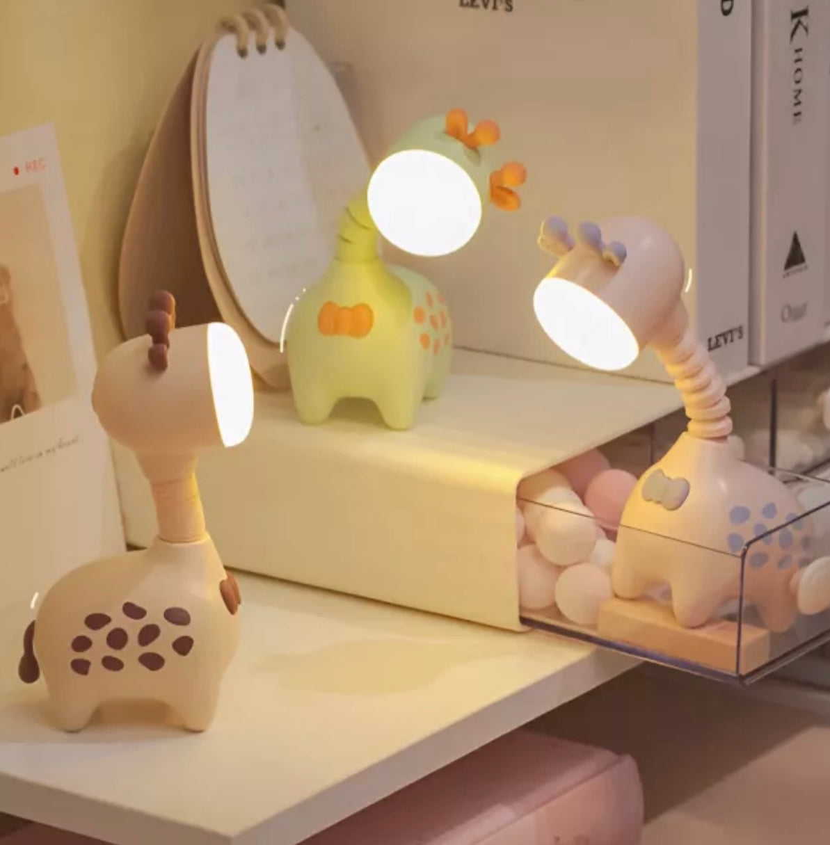 Giraffe-shaped rechargeable LED night light in pink, green, and beige with telescopic neck design