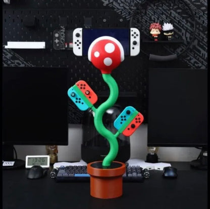 Cannibal flower game console stand holding Nintendo Switch with game card slots and USB base